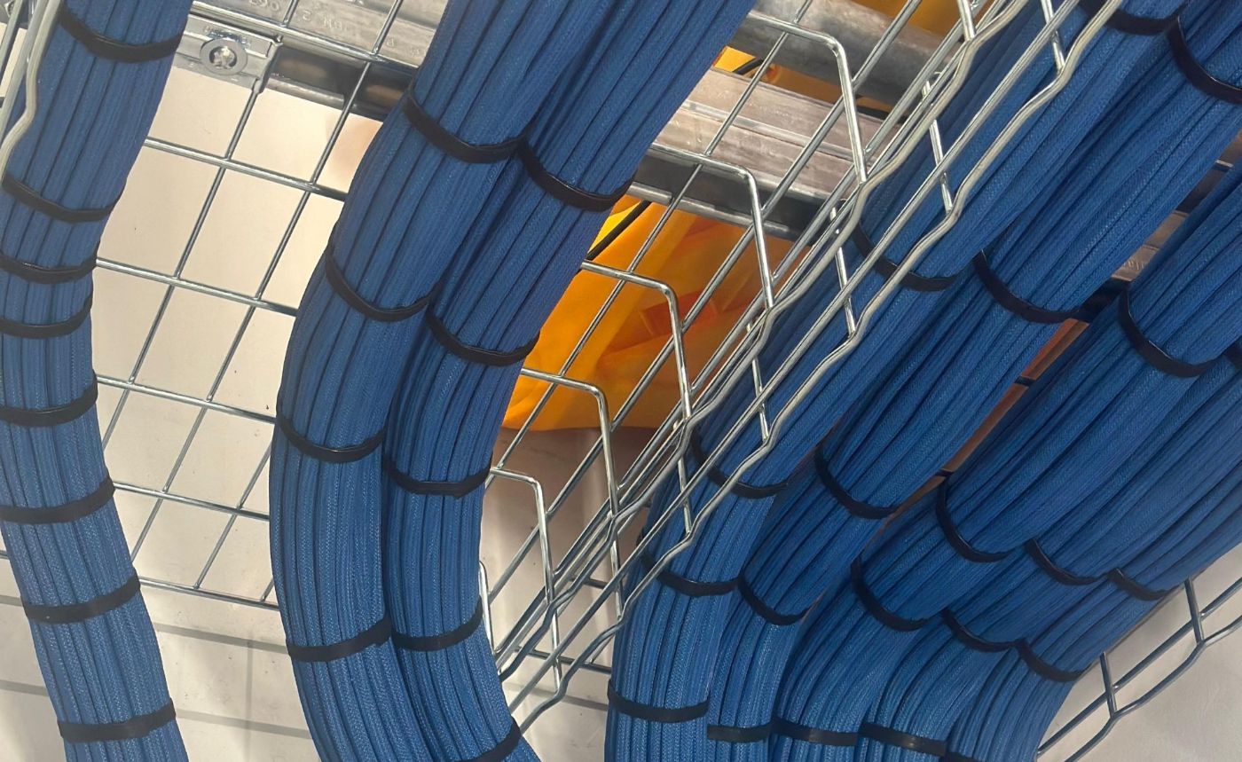Blue InfiniBand cable looms tied and dressed into basket tray
